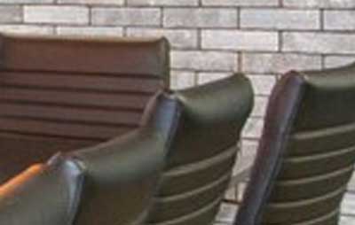 placeholder image for conference room. Closeup detail of chair back and meeting room table.