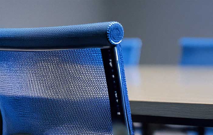 placeholder image for conference room. Closeup detail of chair back and meeting room table.